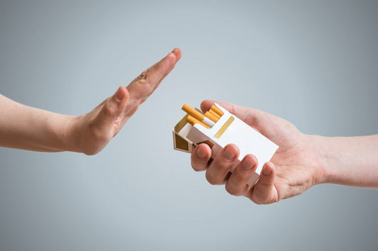 A person offering someone cigarettes