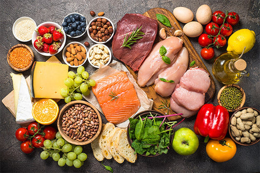 Bunch of vegetables and fruits placed on grey surface