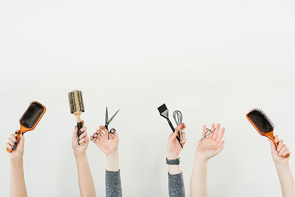 People holding hair care tools