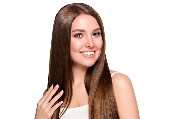 A woman with long brown silky hair smiling 
