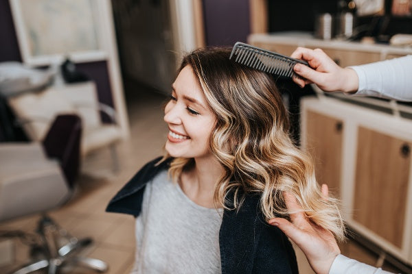 A woman getting her hair styled