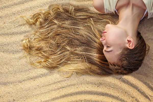 A woman laying on the beach 