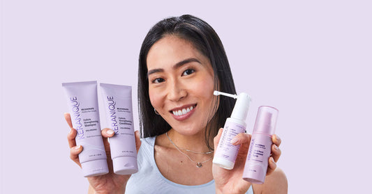 A woman holding Keranique hair regrowth products.