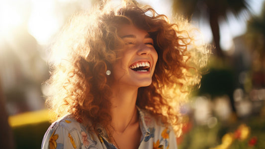 A woman with curly hair outside.