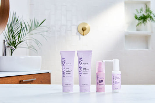 A collection of keranique products placed on a white table 