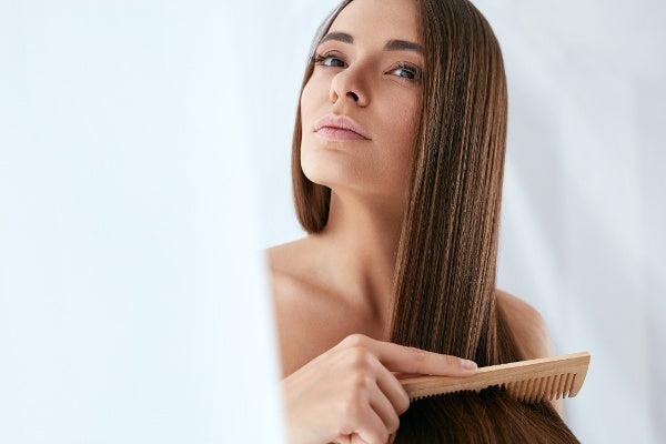 Woman combing her hair.